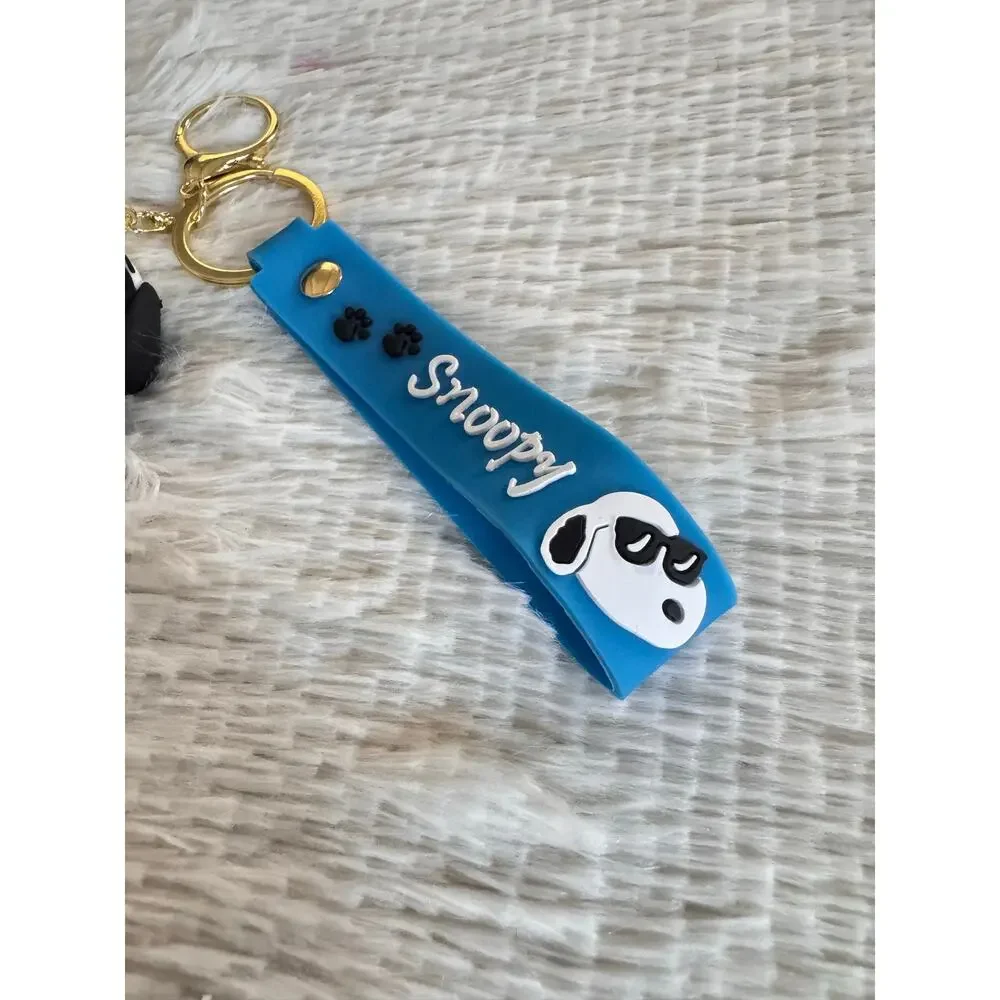 Snoopy suit and red bow tie keychain blue strap and white Snoopy face graphic
